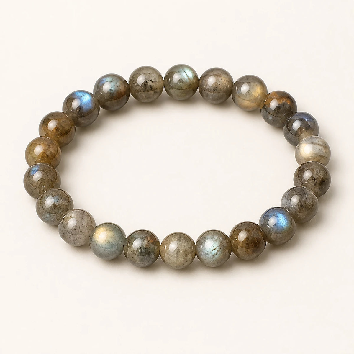 Moonlit Labradorite bracelet with blue-green flash on an ivory background