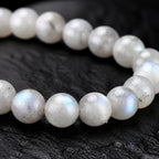 Close-up of pale labradorite beads with natural blue-silver flash