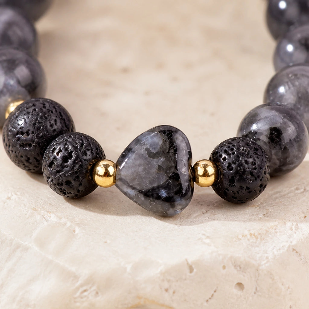 Close-up of gray heart bead and black lava stone bracelet details