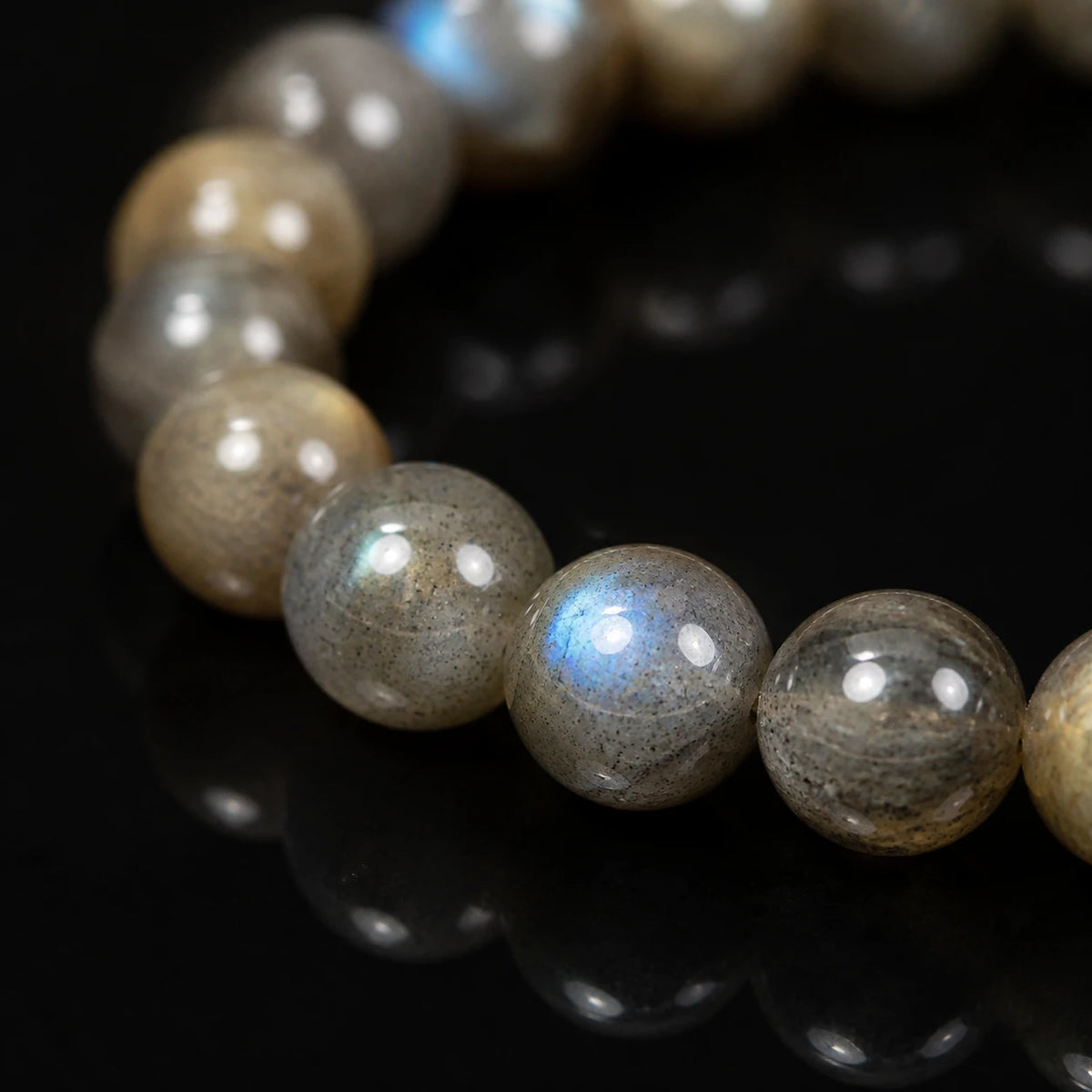 Close-up of polished labradorite beads with a vivid blue flash