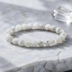 Aurora Flash labradorite bracelet styled in soft moonlight on pale stone