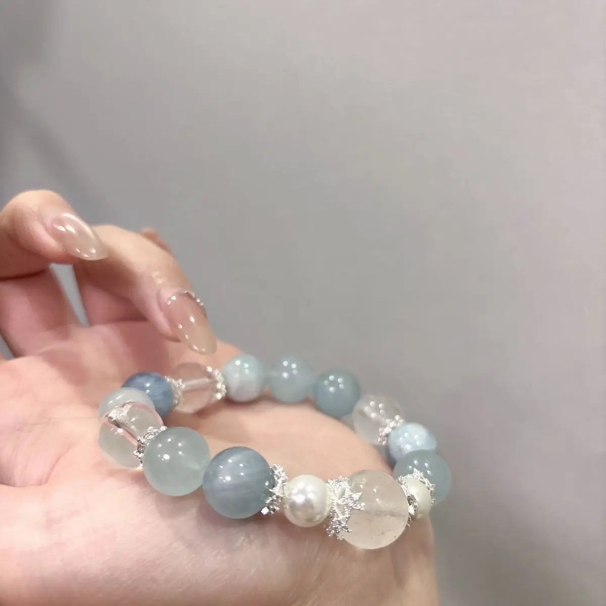 Handmade Aquamarine Bracelet Held in Hand Front View.