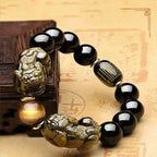 Black obsidian protection bracelet featuring a carved Pixiu charm and engraved bead designed for grounding and mindful daily wear.