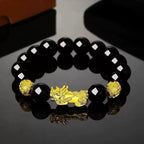 Black Obsidian Pixiu Wealth Bracelet featuring polished obsidian beads and prosperity symbolism.