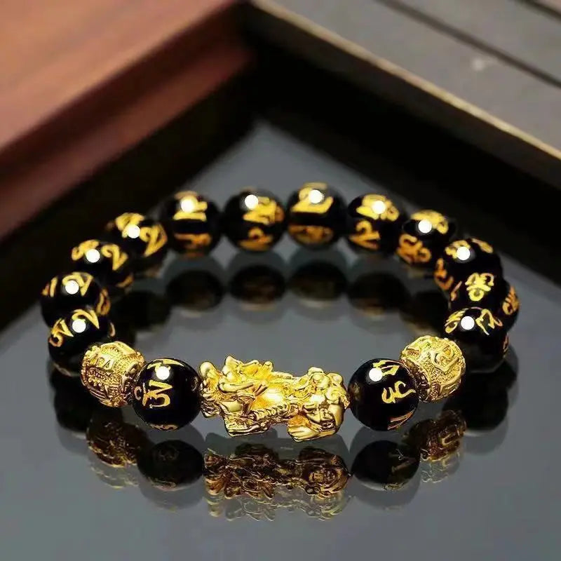 Black Obsidian Pixiu Wealth Bracelet with engraved mantra beads and gold-tone guardian charm.
