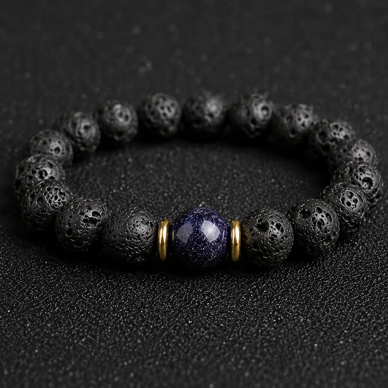 Blue goldstone and lava stone bracelet with gold accents for calm focus, protection, and everyday grounding.