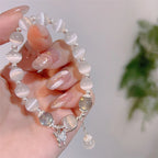Delicate butterfly charm moonstone bracelet lifestyle shot on wrist.