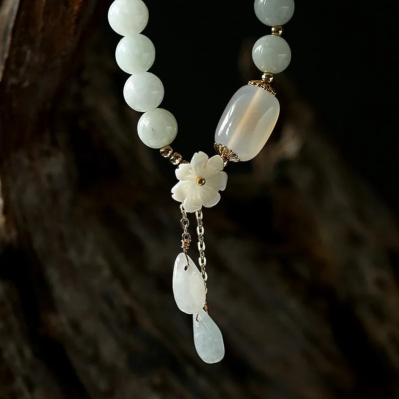 Close-up of Harmony Jade Bracelet floral charm detail.