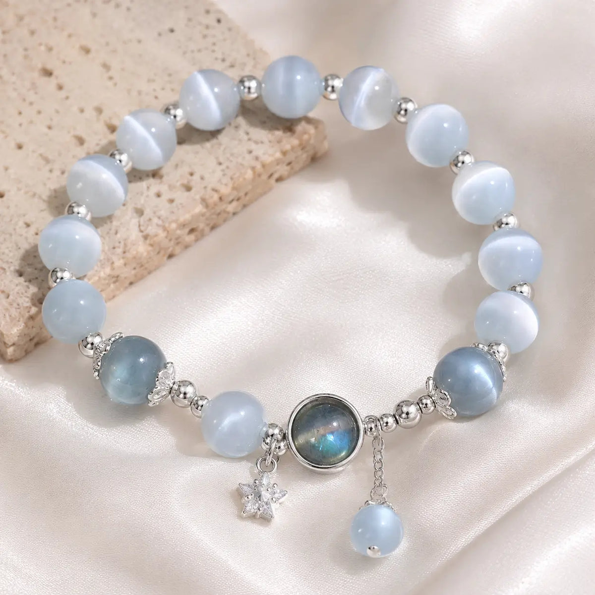 Dark blue moonstone and labradorite variant on luxurious silk background.
