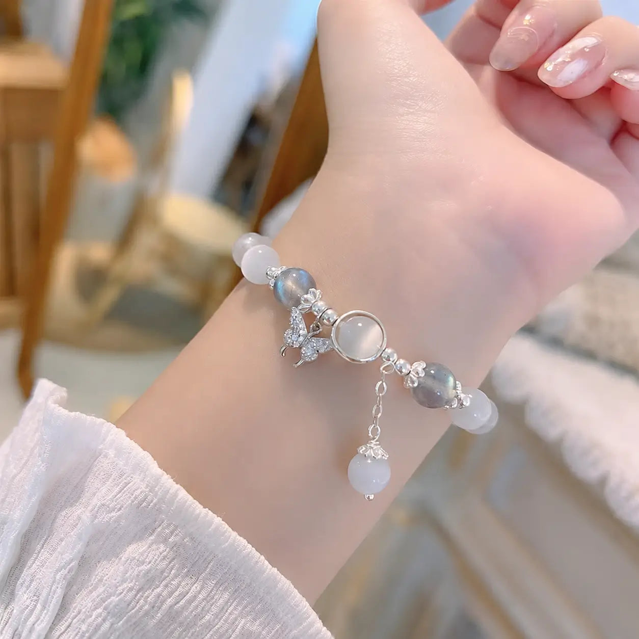 Customer photo: Delicate moonstone butterfly bracelet worn on wrist.