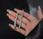 Elegant woman holding luxury crystal flower bracelets with glamorous fashion styling.