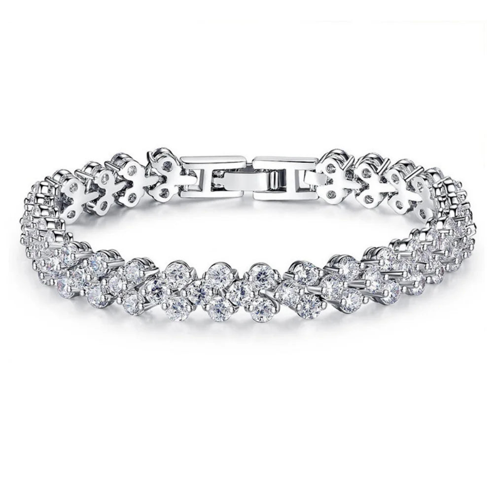Luxury silver flower tennis bracelet with sparkling crystal stones on white background.