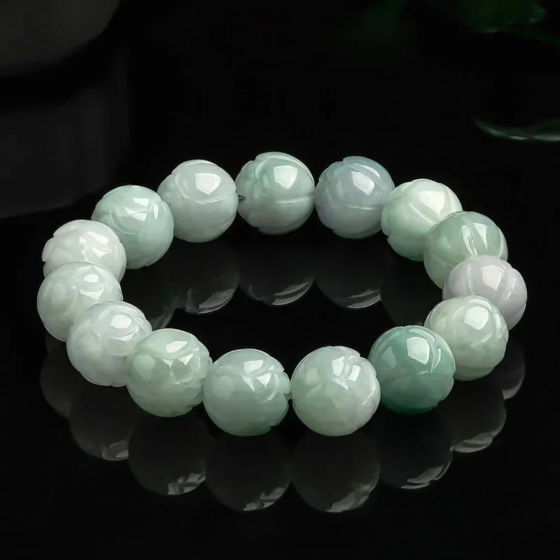 High-quality lotus carving detail on white jade beads.