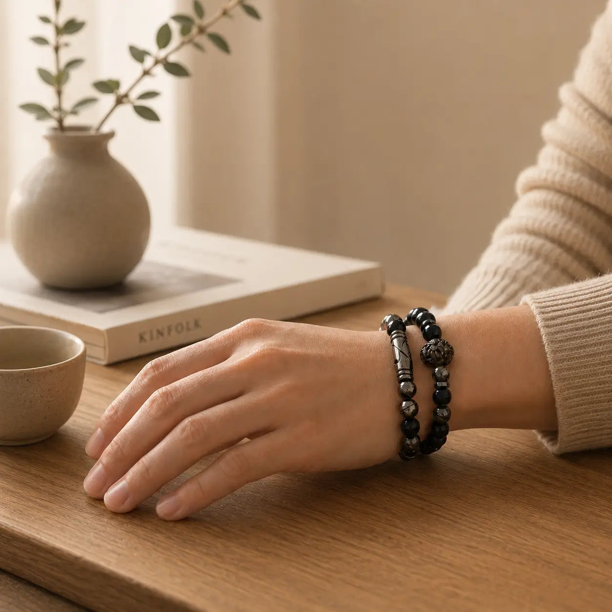 Dark mineral stone bracelet on a man's hand, symbolizing quiet Strength and grounding.