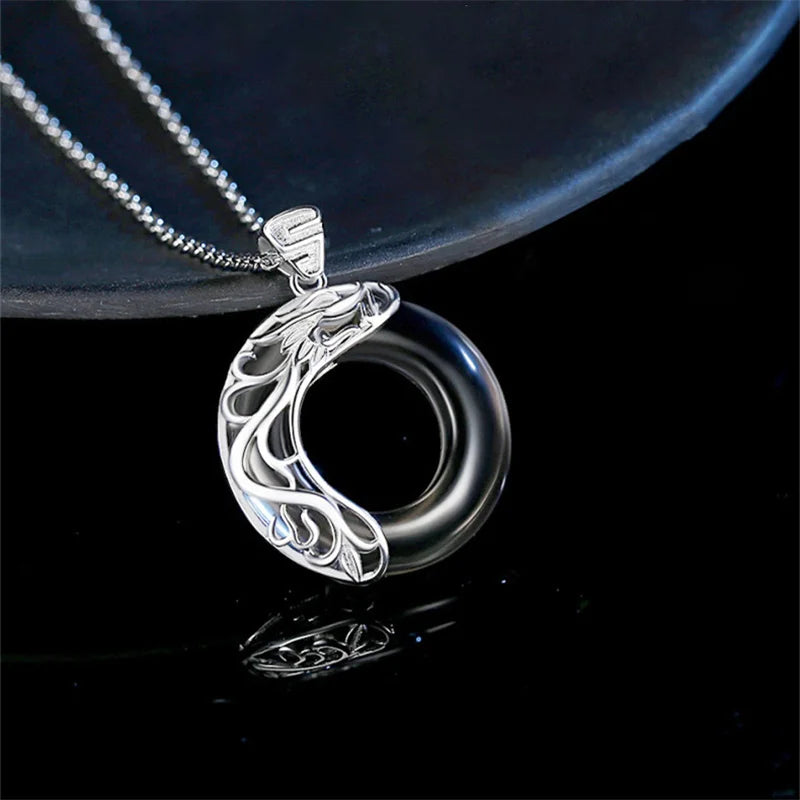 Side view of moonstone koi pendant necklace in sterling silver by Mariv Stones.