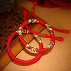 Pair of Tibetan five-color lucky knot bracelets representing friendship, connection, protection, and shared blessings
