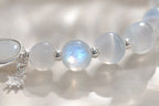 Close-up of natural moonstone beads showing ethereal blue adularescence.