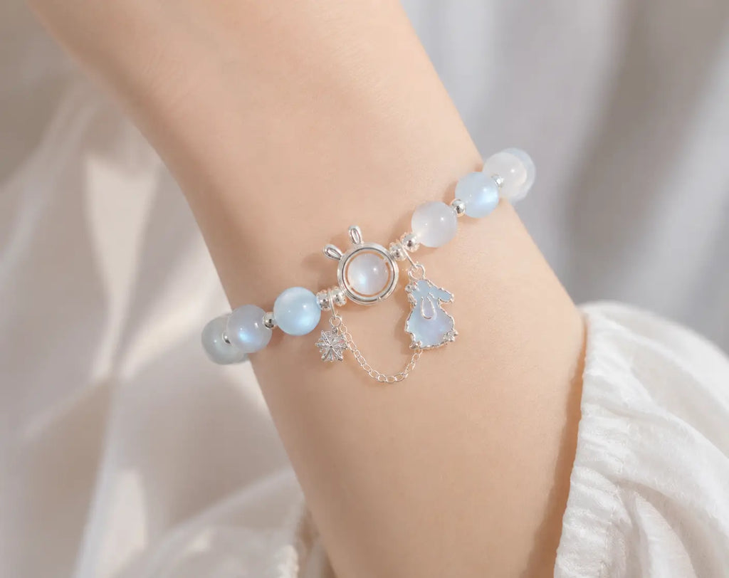 Delicate moonstone rabbit charm bracelet worn on female wrist for lifestyle.