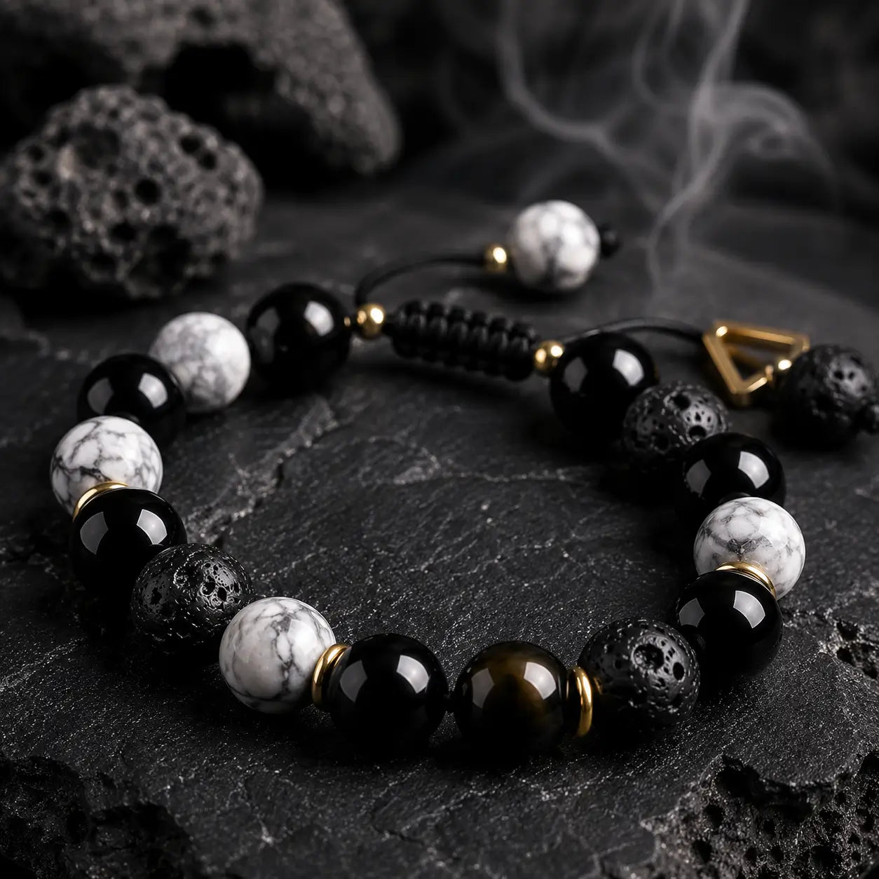 Spiritual lava stone bracelet styled on dark volcanic rock background with calming minimalist aesthetic.