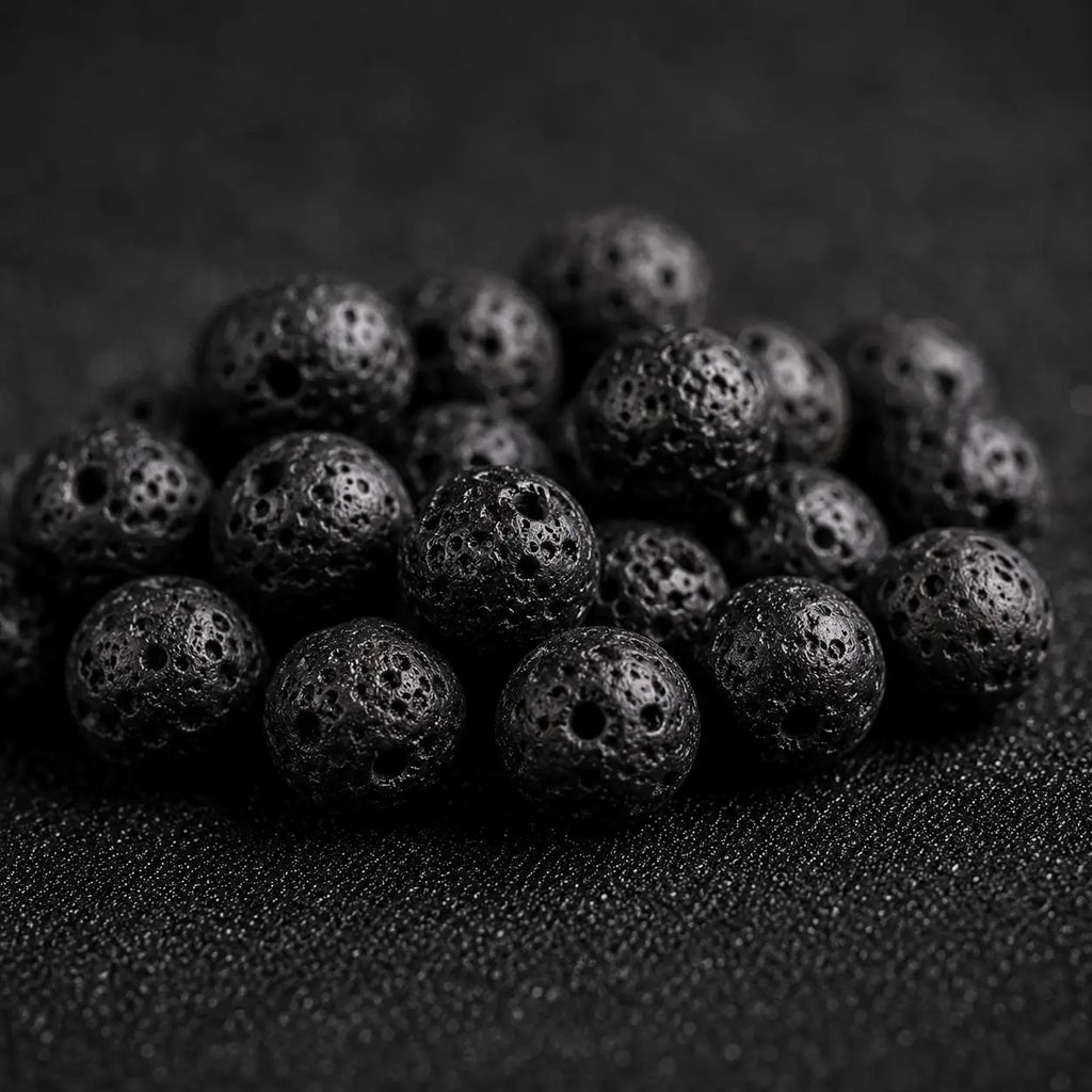 Natural black lava stone beads with porous volcanic texture used in handmade spiritual jewelry.