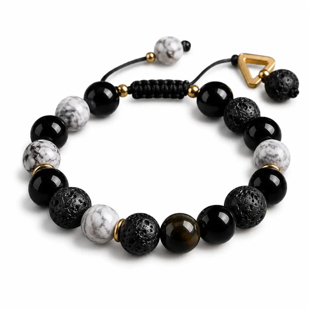 Natural volcanic rock bead bracelet with gold spacer details on white background, modern unisex gemstone jewelry for mindfulness and daily style.