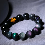 Close-up of a Rainbow Eye Obsidian Protection Bracelet showcasing colorful iridescent obsidian beads and polished gemstone details.