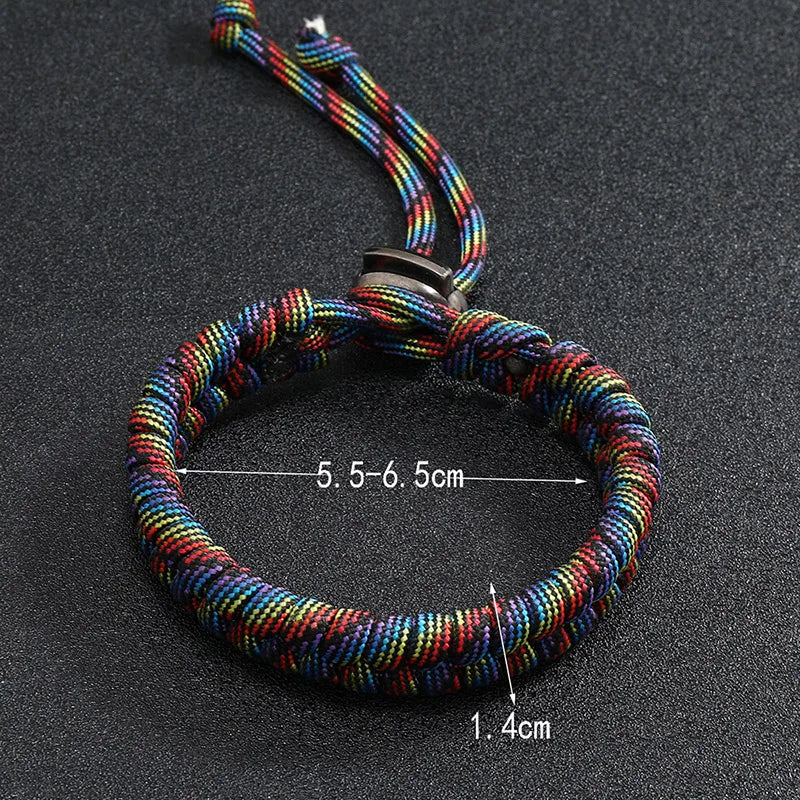 Rainbow handwoven paracord bracelet worn on wrist for casual outdoor style