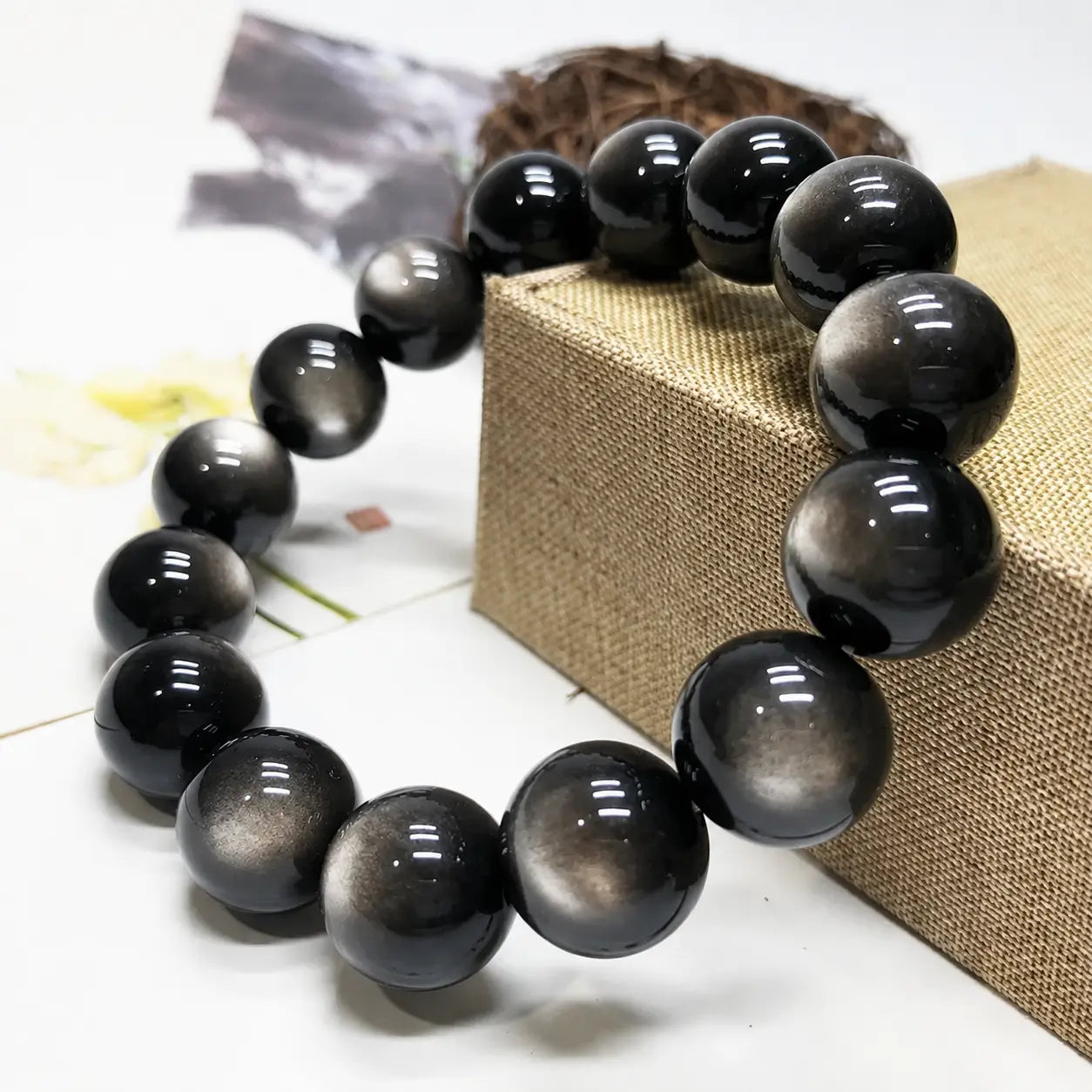 Silver Sheen Obsidian Bracelet showcased on a jewelry display box, highlighting natural silver reflections and everyday elegance.