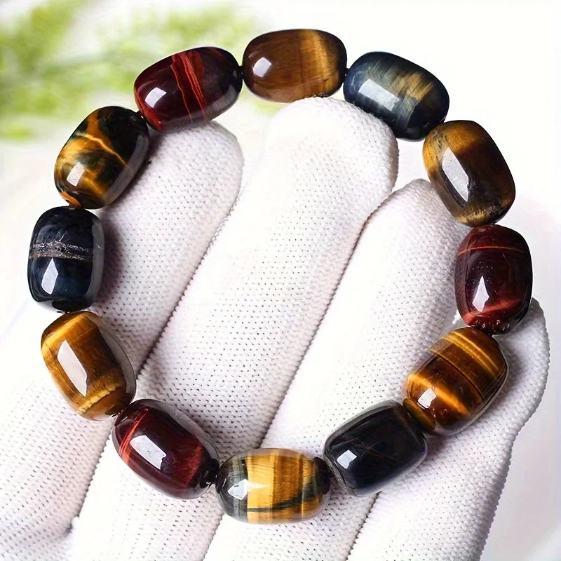 Close-up of a handmade tiger eye protection bracelet worn on a wrist.