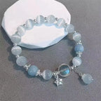 Translucent moonstone beaded bracelet held in hand to show bead clarity.