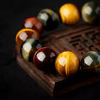 Close-up of polished triple tiger eye crystal bracelet with glossy gemstone texture and luxury dark background.