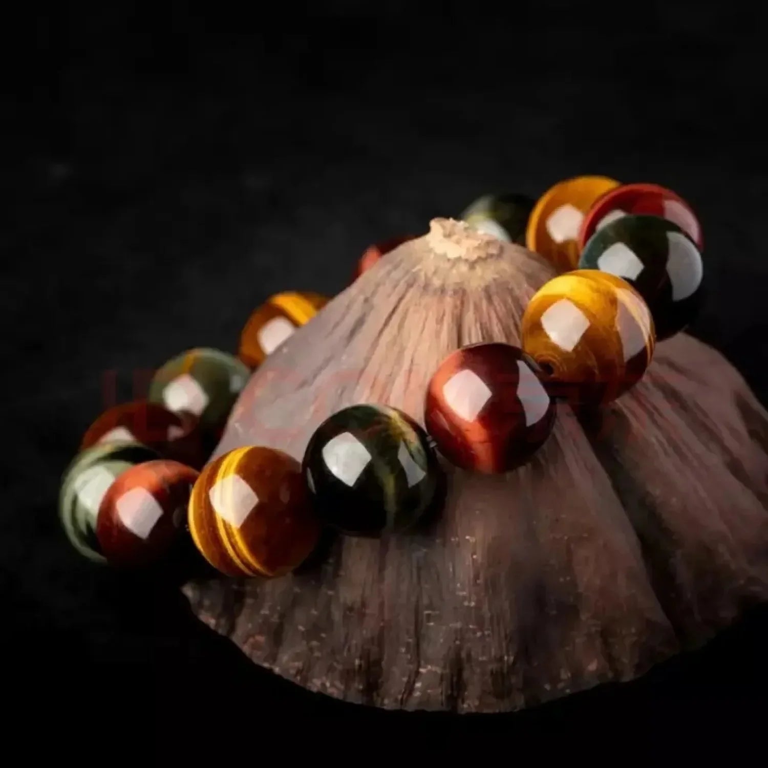 Natural tiger eye crystal bracelet photographed on textured shell with calming spiritual jewelry style.